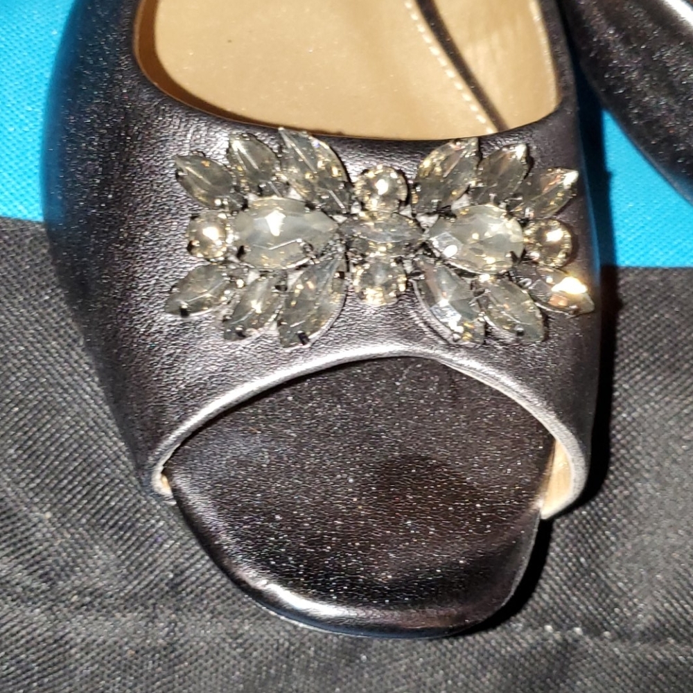 Never worn.. Silver sling back shoes. 1 1/4" heel
